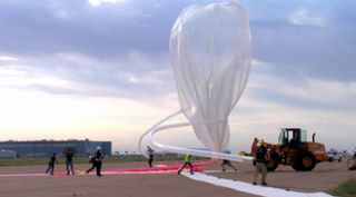 Workers fill a balloon on June 18, 2014, during the lead-up to the first test flight by Arizona-based company World View, which aims to start carrying passengers on near-space cruises by 2016.
