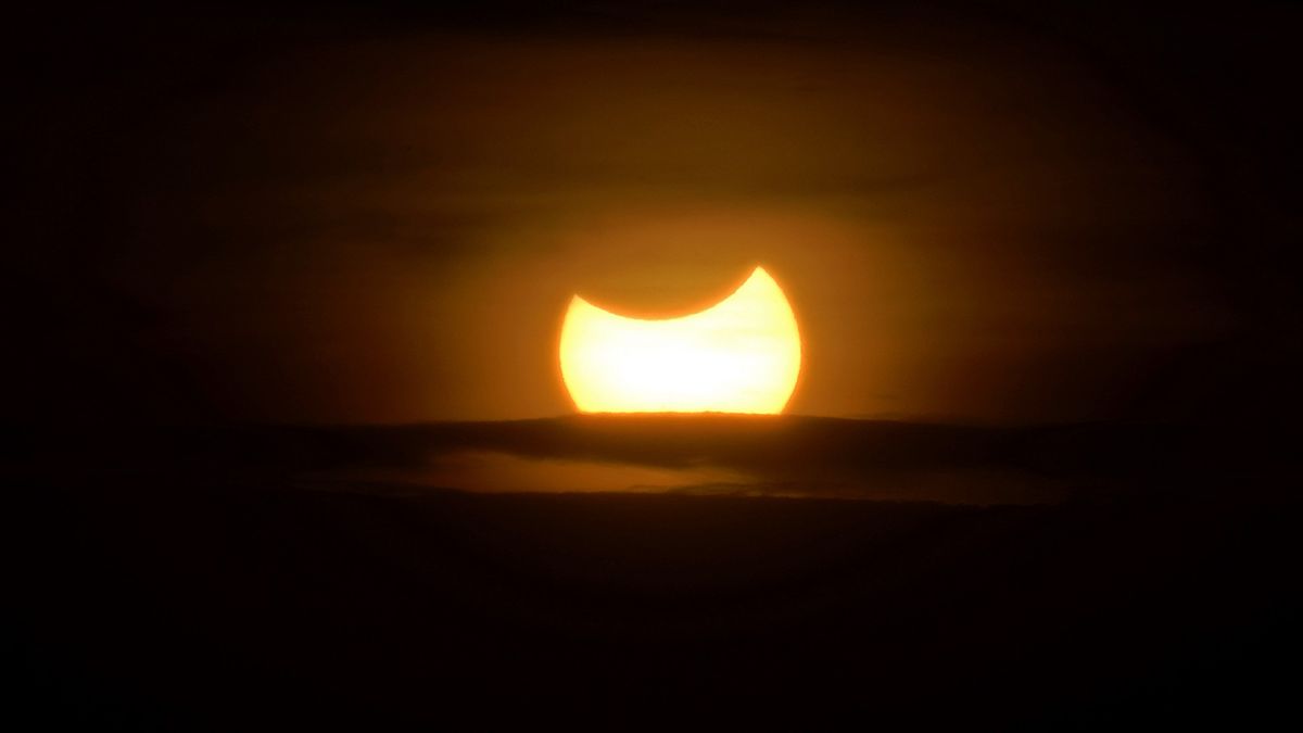 The moon blocks the sun in a rare hybrid solar eclipse today | Space