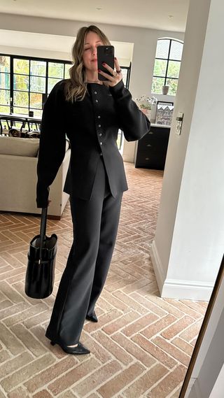 tailored black trouser suit worn with all black accessories