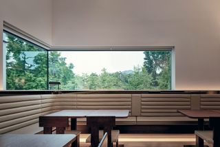 The restaurant at the K1 arts complex, with custom walnut furniture by Teo Yang and windows facing Gyeongbokgung Palace