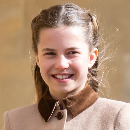 Princess Charlotte wearing a brown coat and smiling