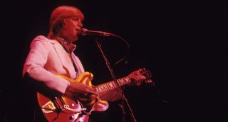 Justin Hayward of the Moody Blues wears a white jacket and plays his Bigsby-equipped red ES-335 as he fronts the band onstage at Madison Square Garden in 1978.