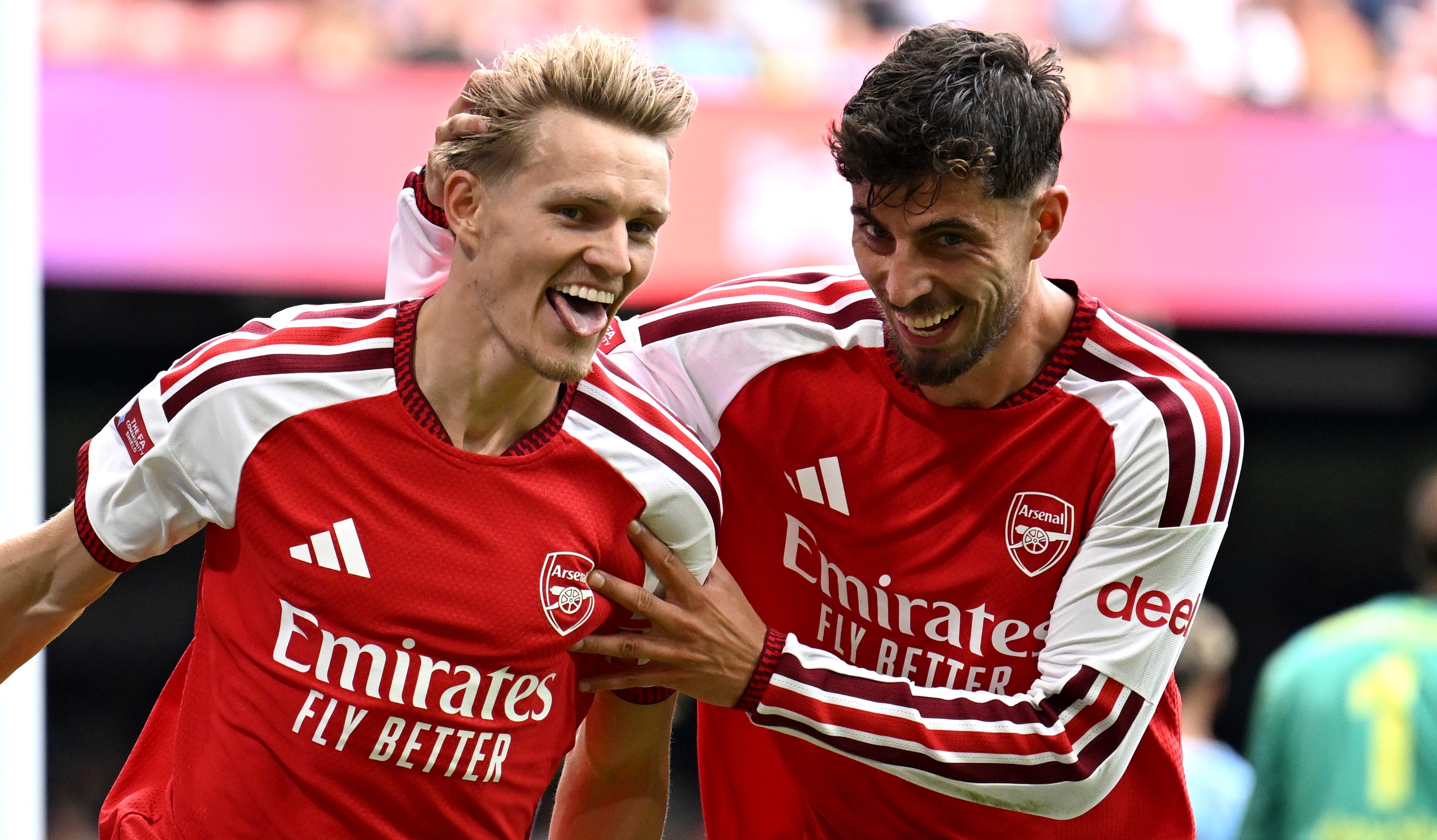 Martin Odegaard celebrates scoring Arsenal's third goal with Kai Havertz during the 2026 FA Community Shield match against Manchester City at Principality Stadium on August 16, 2026 in Cardiff, Wales