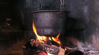 a pot roasting over a fire