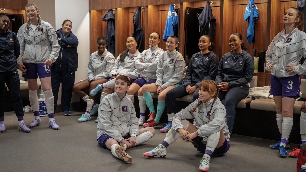 Members of AFC Richmond Women sitting on the floor and on benches in Ted Lasso season 4 episode 9