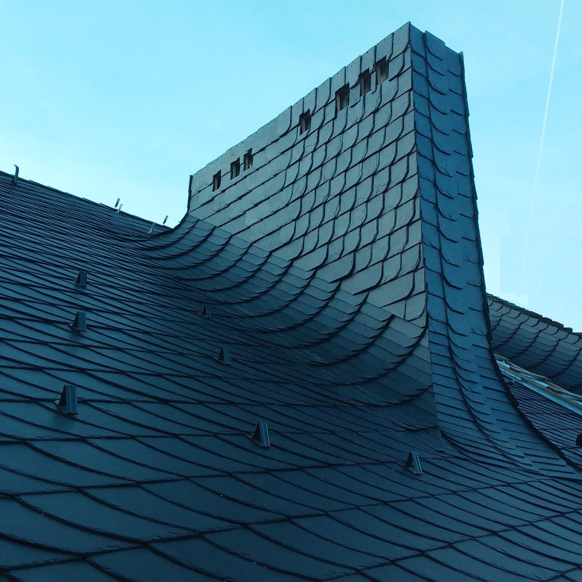 Bespoke roof and chimney stack clad in Schuppen format slate