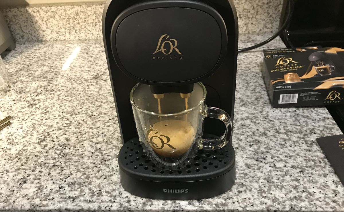 L’OR Barista Coffee &amp; Espresso System brewing a coffee on kitchen countertop