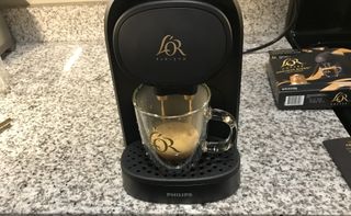 L’OR Barista Coffee & Espresso System brewing a coffee on kitchen countertop