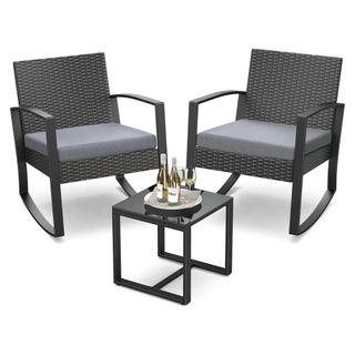 An Aiho 3 Piece Patio set - two modern black rocking chairs and a small glass table