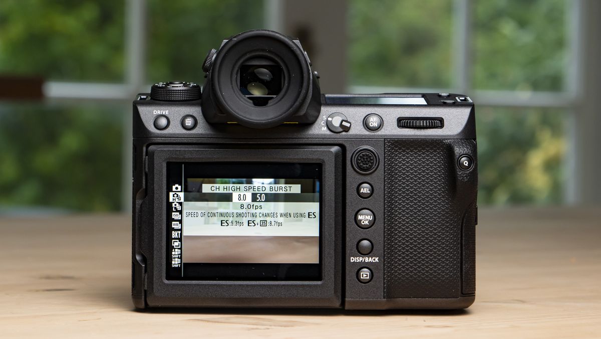 Fujifilm GFX100 II on a wooden table rear of the camera with burst mode on screen
