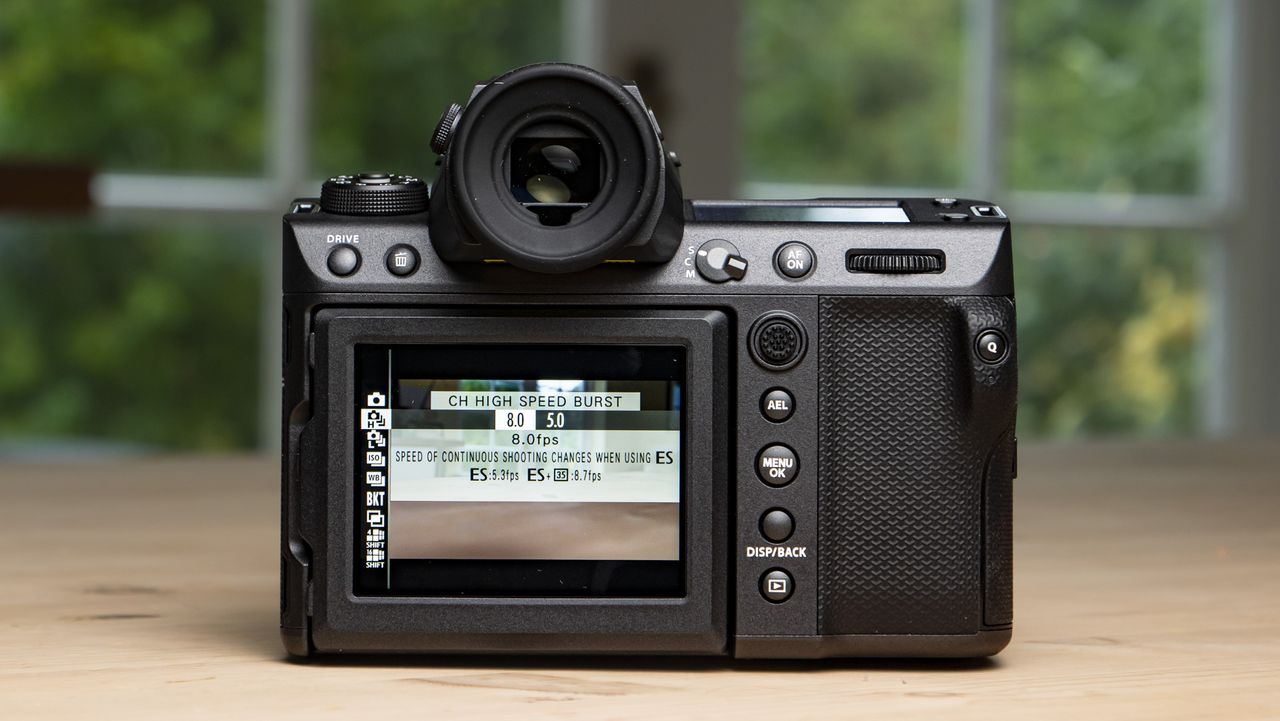 Fujifilm GFX100 II on a wooden table rear of the camera with burst mode on screen