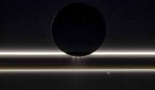 Future missions to sample the plumes of Enceladus (seen here pictured in silhouette against Saturn’s rings by NASA's Cassini spacecraft) or Jupiter's moon Europa should carry with them experiments to detect virions and viruses, some scientists say.