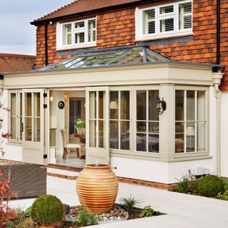 conservatory with white window and glass door frames