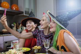 Three women dressed up for Halloween taking a selfie