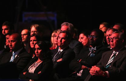 Audience members watch the CNBC Republican Presidential Debate