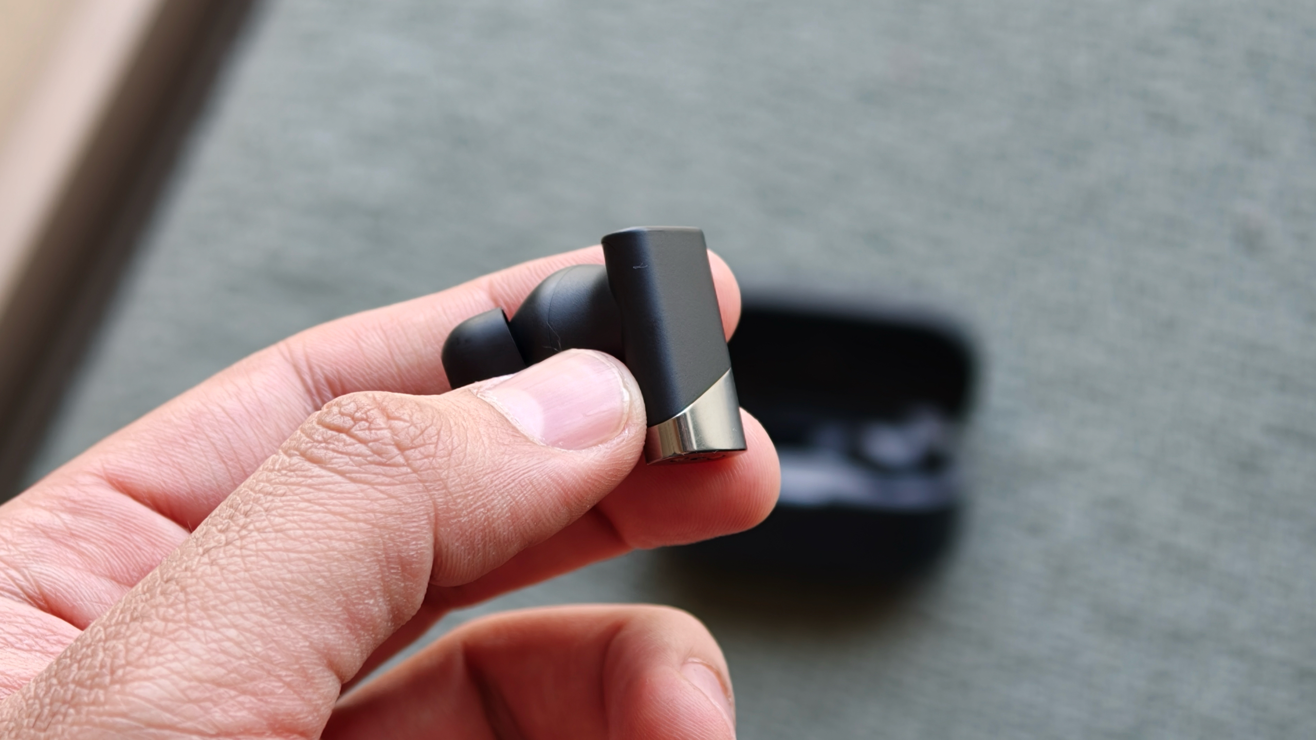 Status Audio Pro X headphones in hand