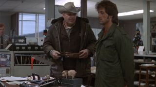 Brian Dennehy as Sheriff Teasle, in a police station with Sylvester Stallone as John Rambo