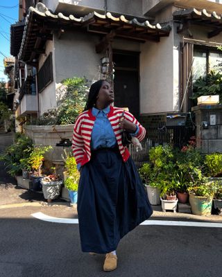 Influencer wears a striped cardigan.