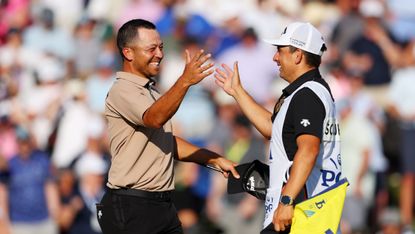 Xander Schauffele and his caddie celebrate winning the 2024 PGA Championship