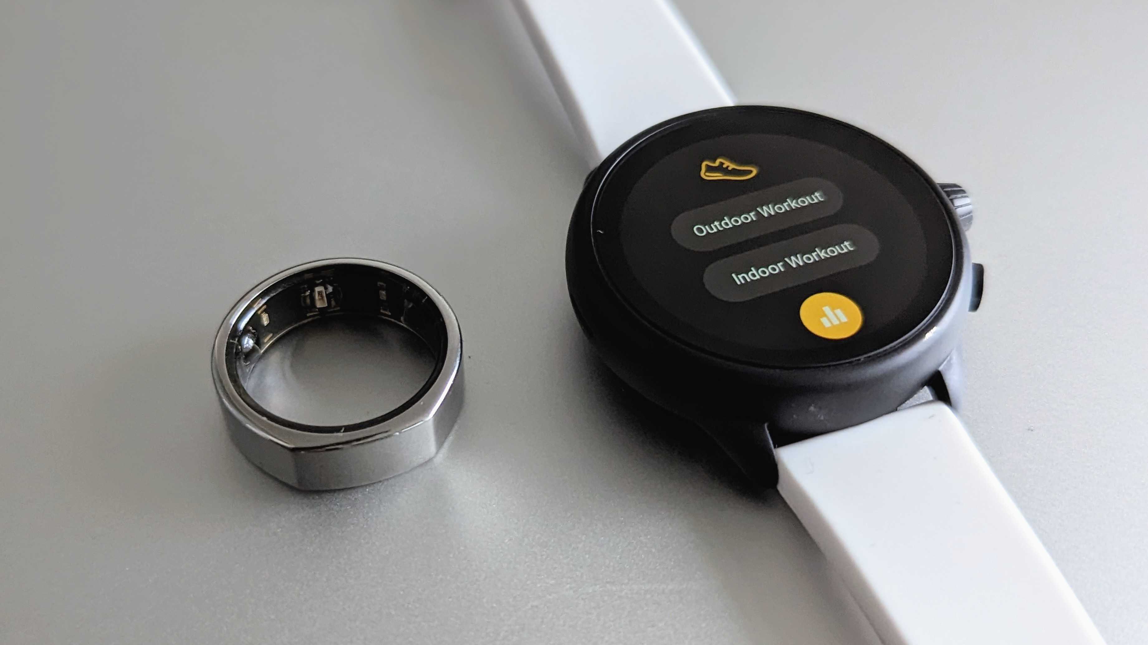 The Oura Ring (Gen 3) next to the Fossil Gen 6 Wellness Edition