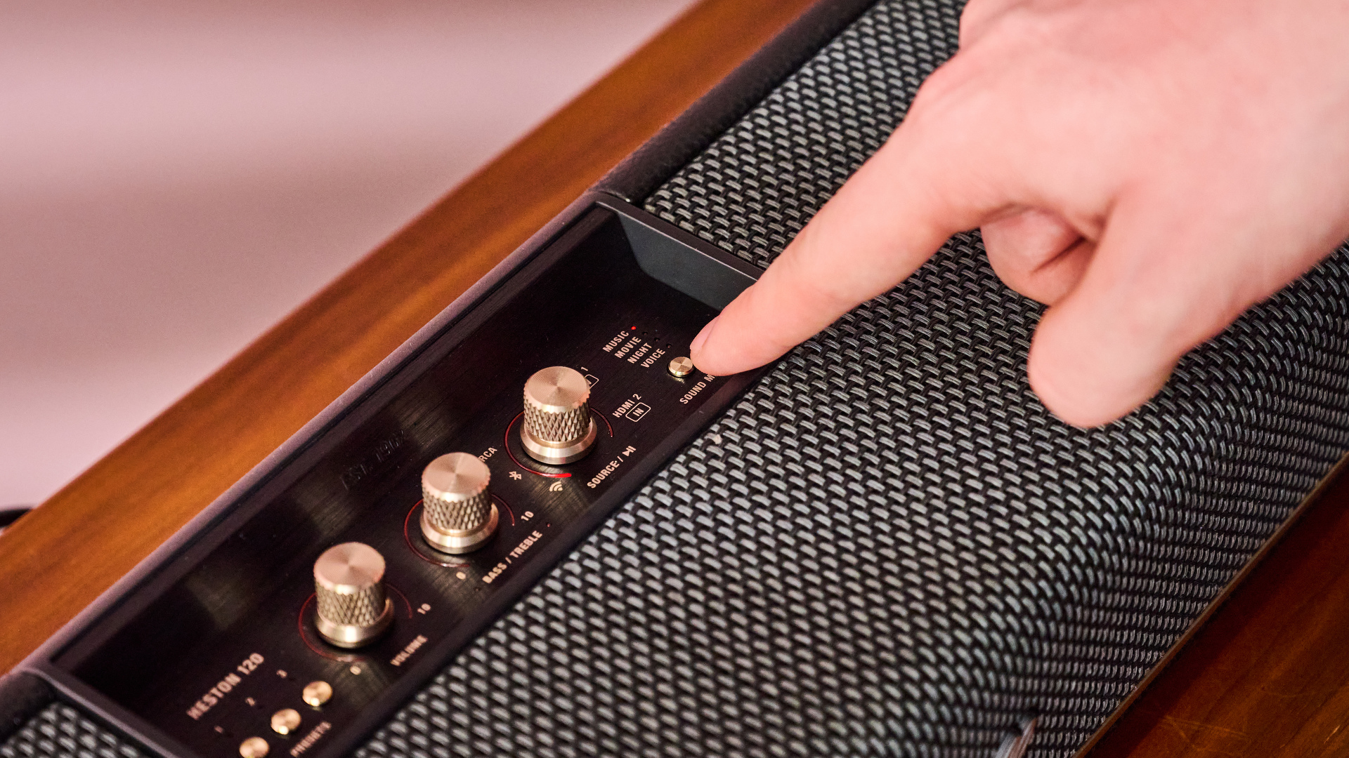 Person pressing sound mode button on the Marshall Heston 120