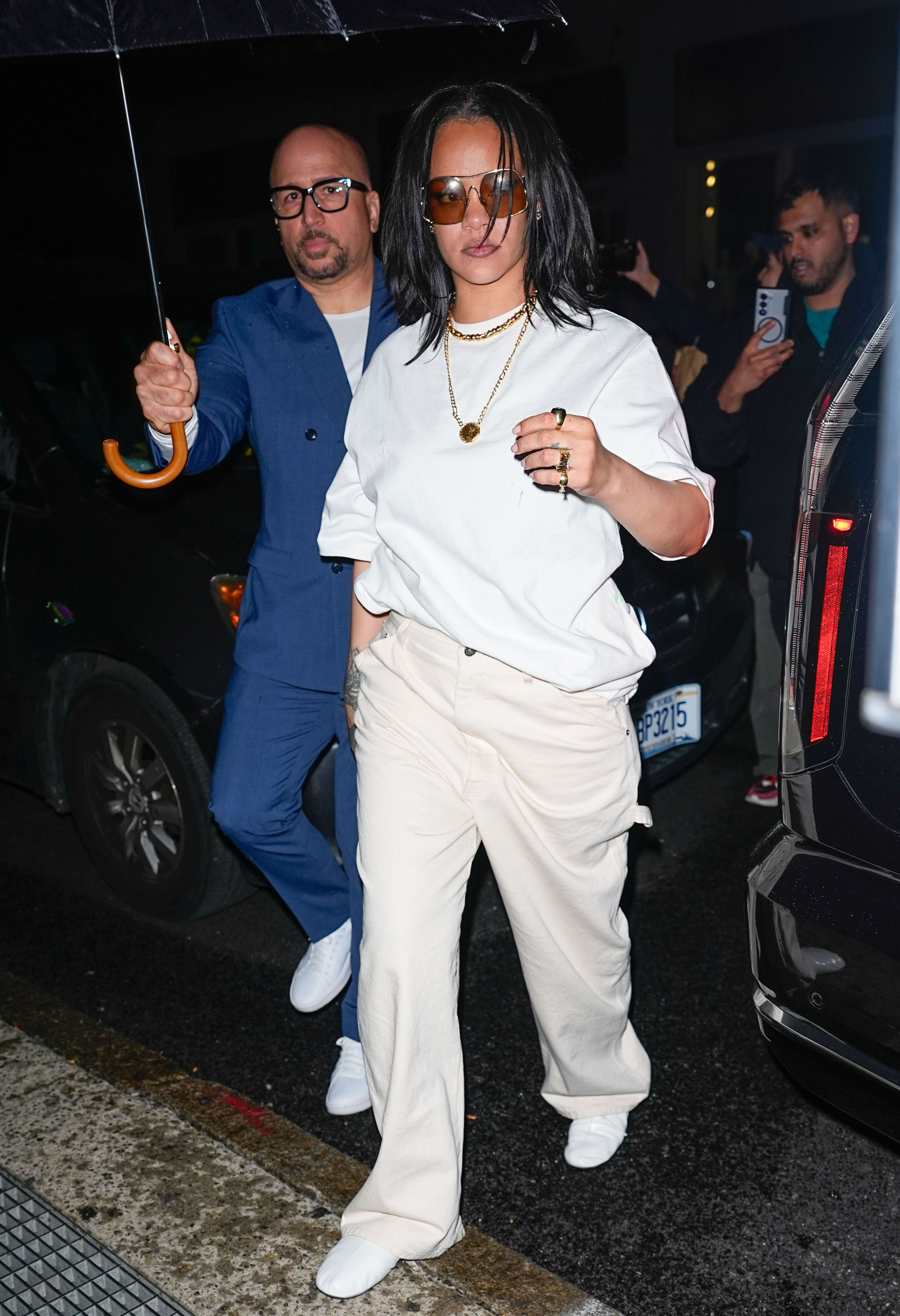 Rihanna wore an oversize white T-shirt with the white jeans trend and high-vamp flats