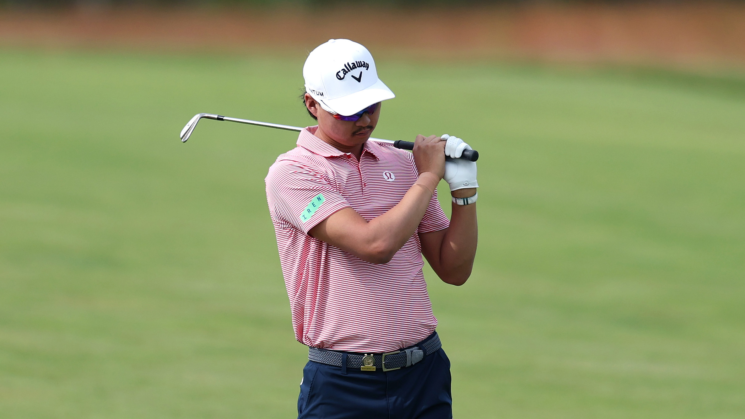 Min Woo Lee looks down in disappointment after hitting an iron shot