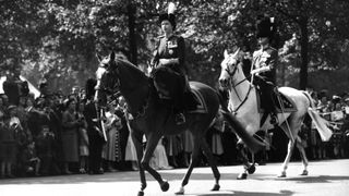 Queen Elizabeth II in front of Prince Philip, Duke of Edinburgh en route to Horse Guards parade, London for a Trooping of the Colour ceremony