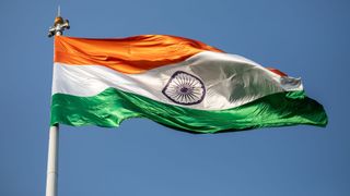 The Indian flag flying against a clear blue sky