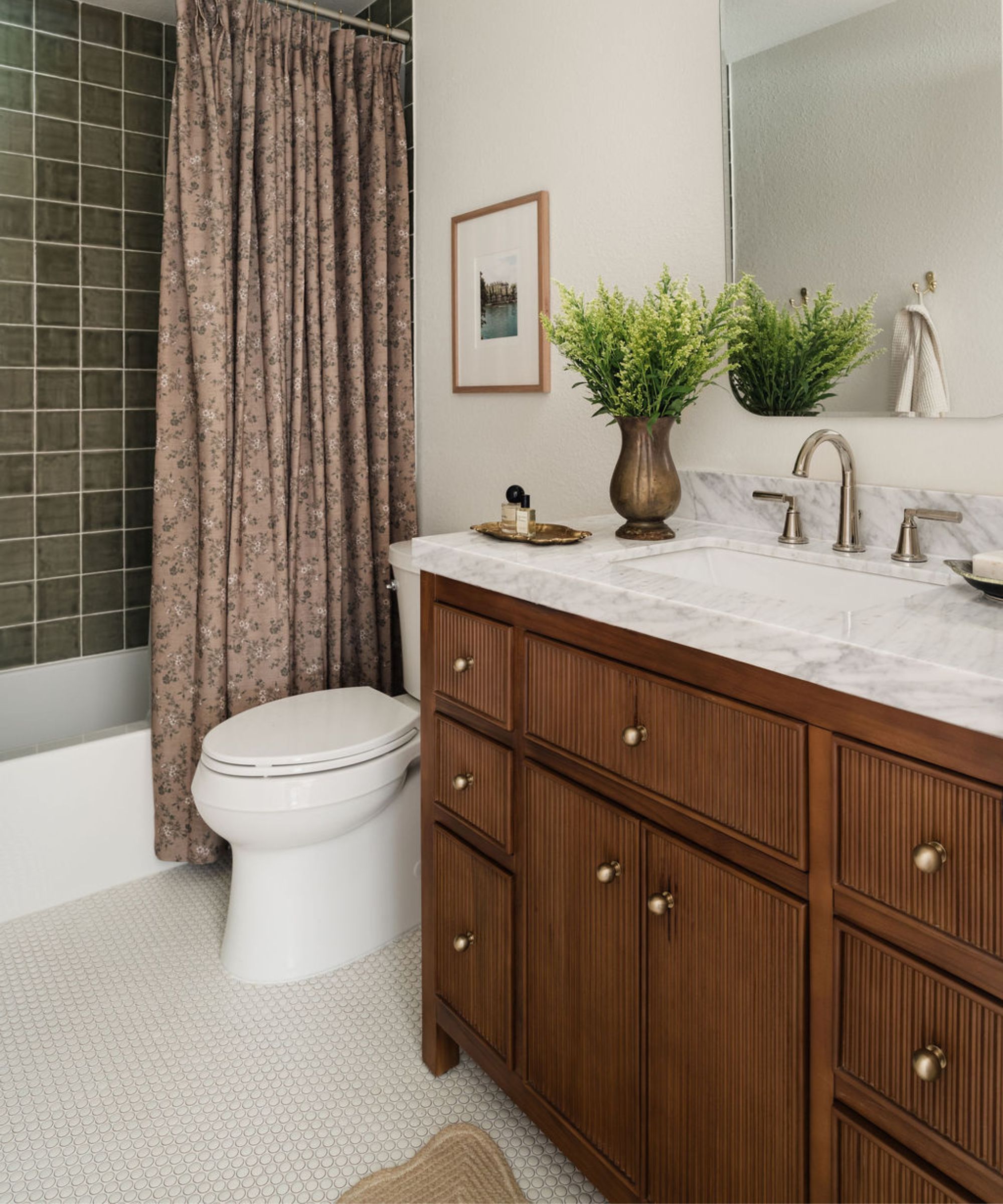 White and green bathroom with a wooden reeded vanity
