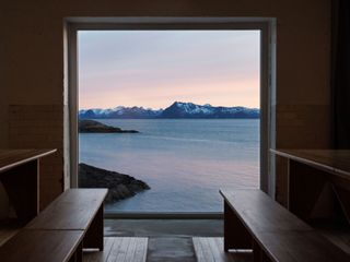 Framed view of fjord from interior of Trevarefabrikken hotel Norway