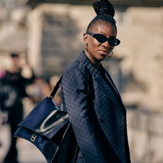 Nikki Ogunnaike wearing a navy blazer and sunglasses 