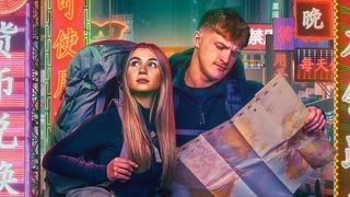 Contestants Fin and Sioned looking at a map in a promotional image for Race Across the World season 5.