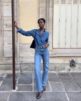 @sylviemus_ wears a mid-blue denim shirt, matching jeans and mules