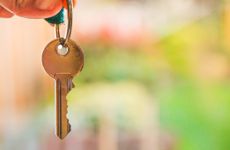 Someone holds an old key in front of the camera.