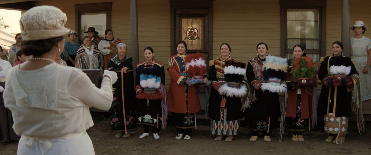 Killers of the Flower Moon wedding scene, people holding Osage ribbon work skirts