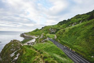 Cyclists ride along a coastal road in Ireland at the Chase the Sun sportive