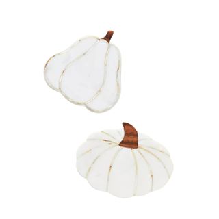 Two white pumpkin shaped coasters with dark wooden stems and pearl inlay lines