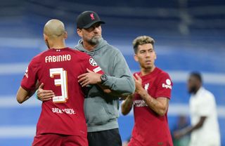 Juergen Klopp, Manager of Liverpool, embraces Fabinho after the UEFA Champions League round of 16 leg two match between Real Madrid and Liverpool FC at Estadio Santiago Bernabeu on March 15, 2023 in Madrid,