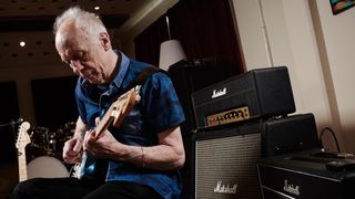 Robin Trower, seated in a studio