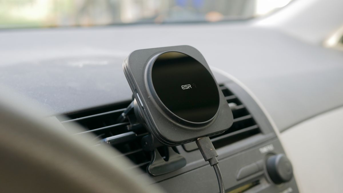 ESR HaloLock MagSafe Car Charger attached to vent clip in car with iPhone.