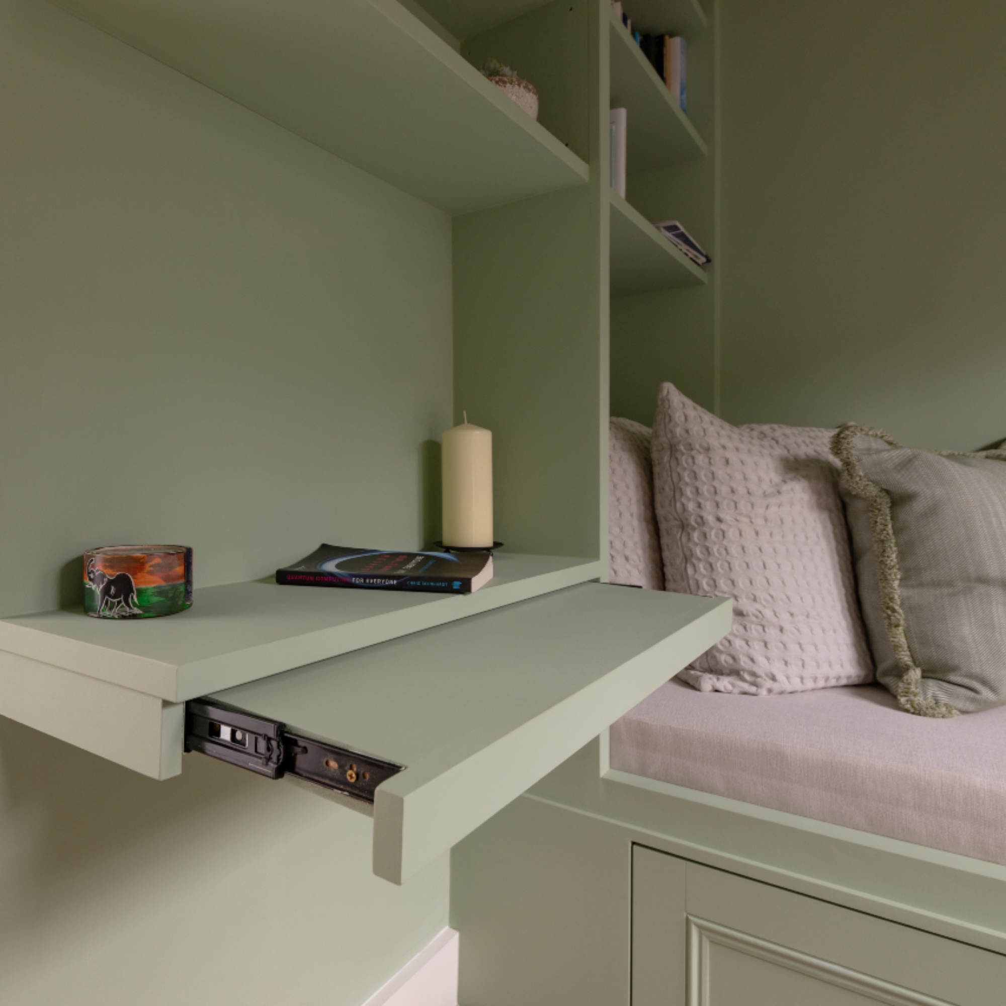 detail of built in day bed and wall storage with pull out shelf