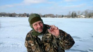 Meteorite-hunter Larry Atkins poses with one of the meteorites found on Jan. 18, 2018, two days after a meteor caused a spectacular fireball in the Michigan night sky.