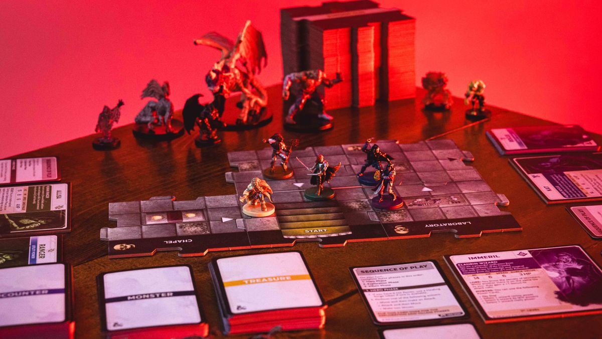 Castle Ravenloft board game components laid out on a dark table, with an ominous red glow on them