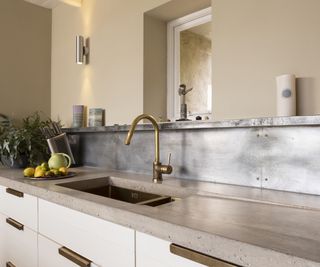 kitchen sink with metal splashback