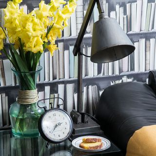 room with black lamp light and yellow flower vase