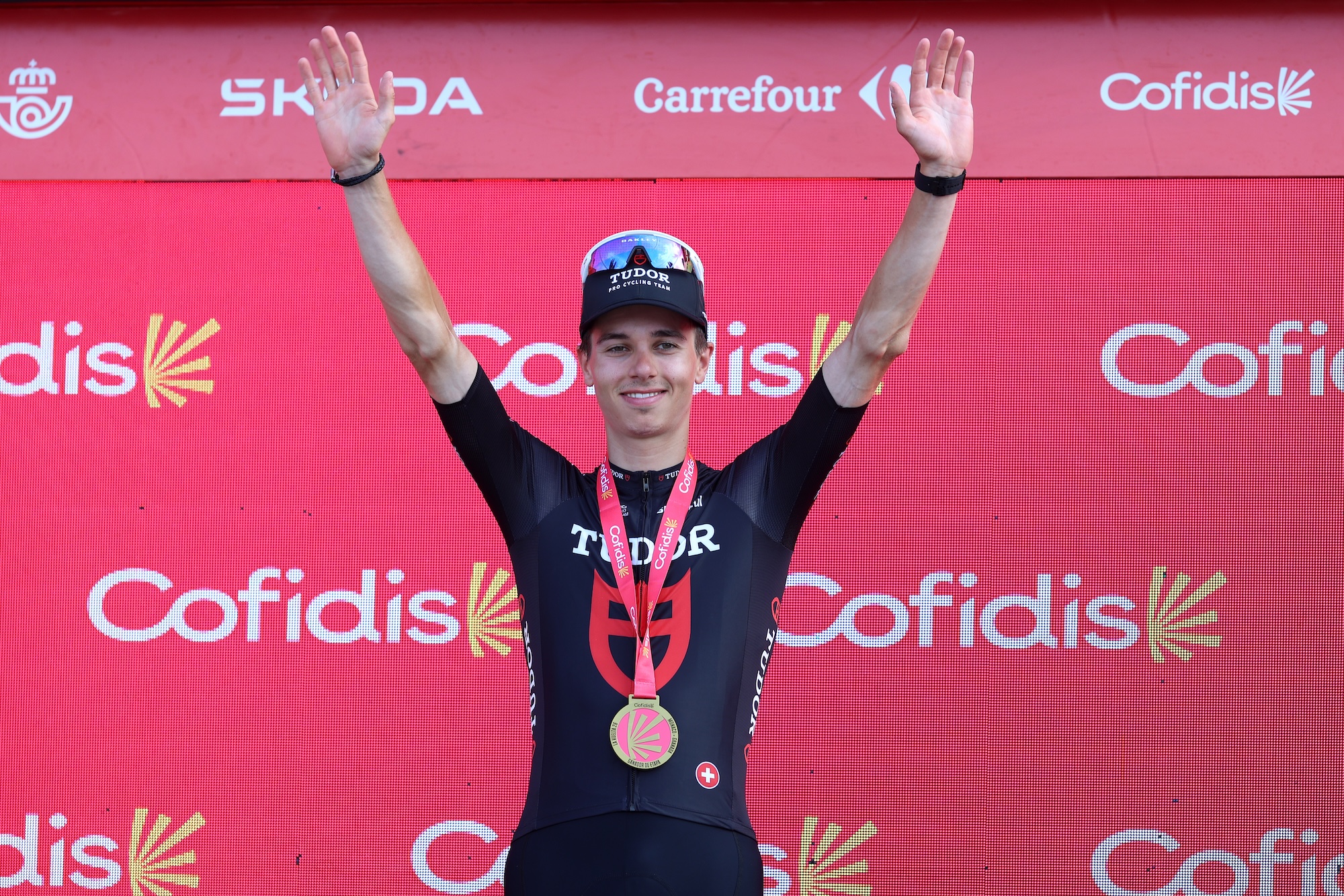 Marco Brenner of Tudor Pro Cycling celebrates at podium as stage 14 winner