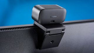 A black Insta360 Link 2C webcam with a magnetic L-shaped mount