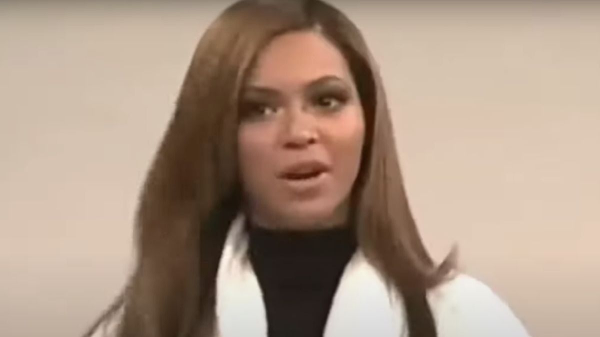 Beyoncé wearing a robe, playing herself in a sketch on SNL