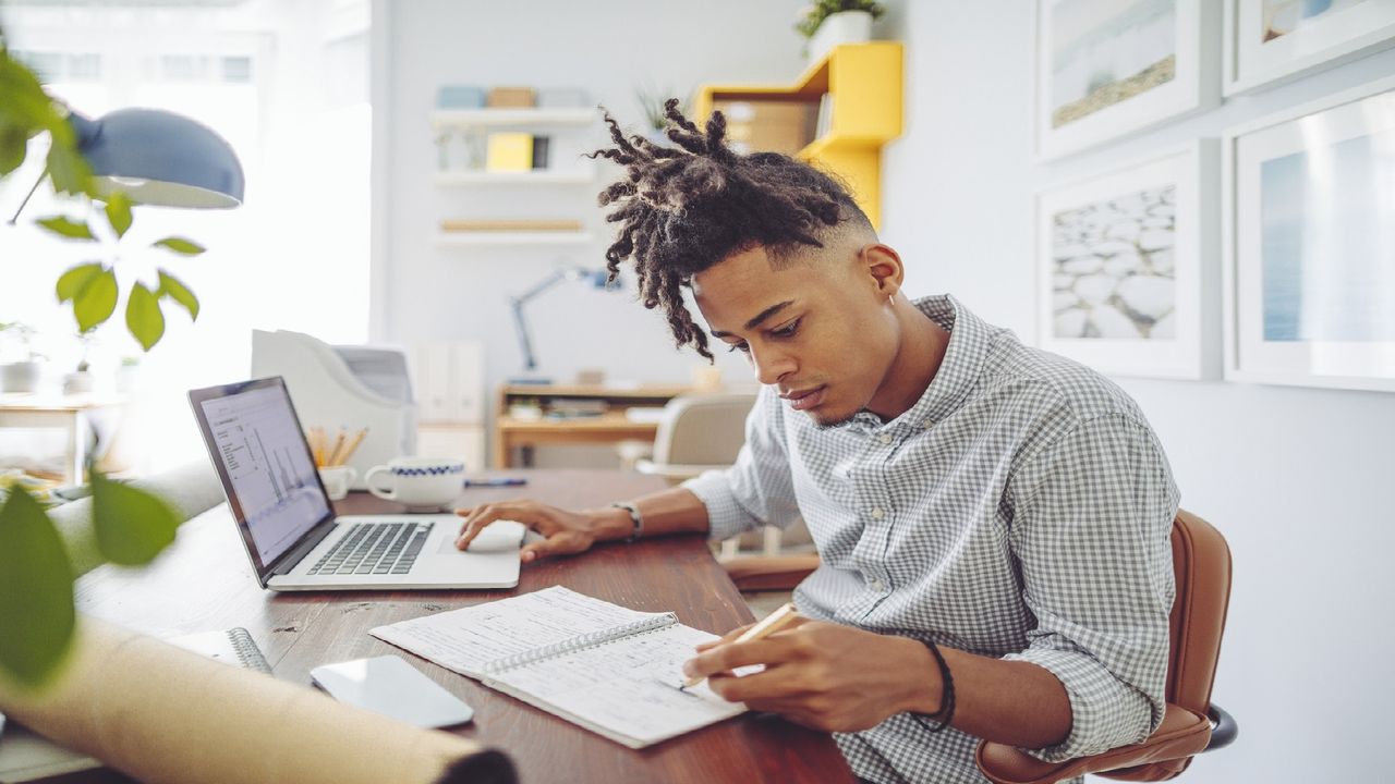 A Gen Z man works on his computer.